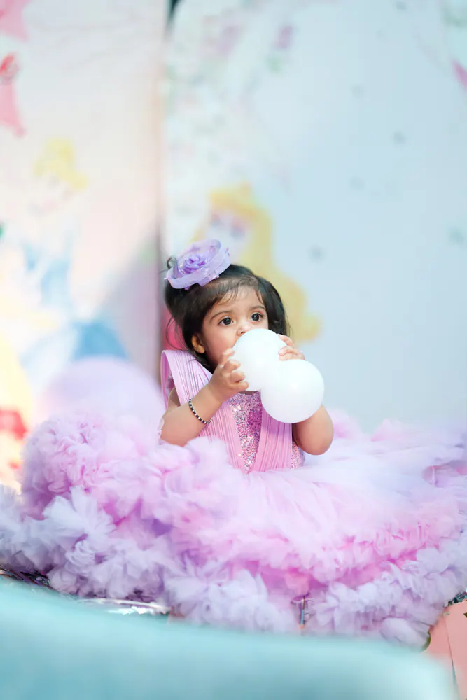 Little girl in a fluffy lilac tutu dress at her birthday shoot