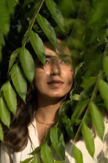 Portrait of a model framed by green leaves