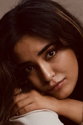 Moody close-up portrait of a model resting her chin on her hand